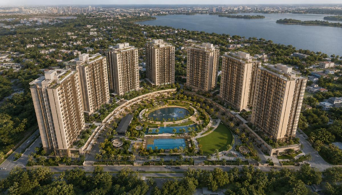Aerial master view of Prestige Rosewood — six residential towers arranged around the central landscaped courtyard, with Varthur Lake adjacent, in late afternoon light.